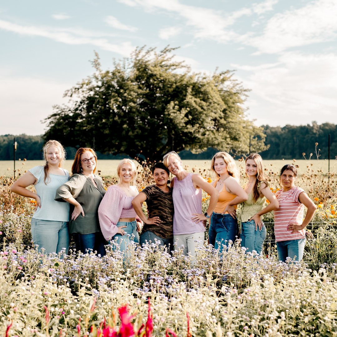 wildlynativeflowerfarmteammembers Group photo of the team behind Wildly Native Flower Farm, standing in the flower field together smiling at the camera