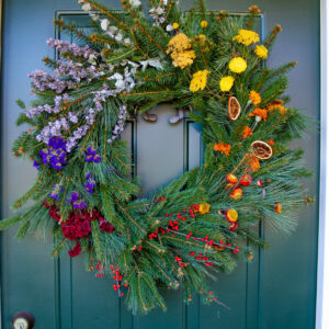 Rainbow Wreath hangs on a front door.