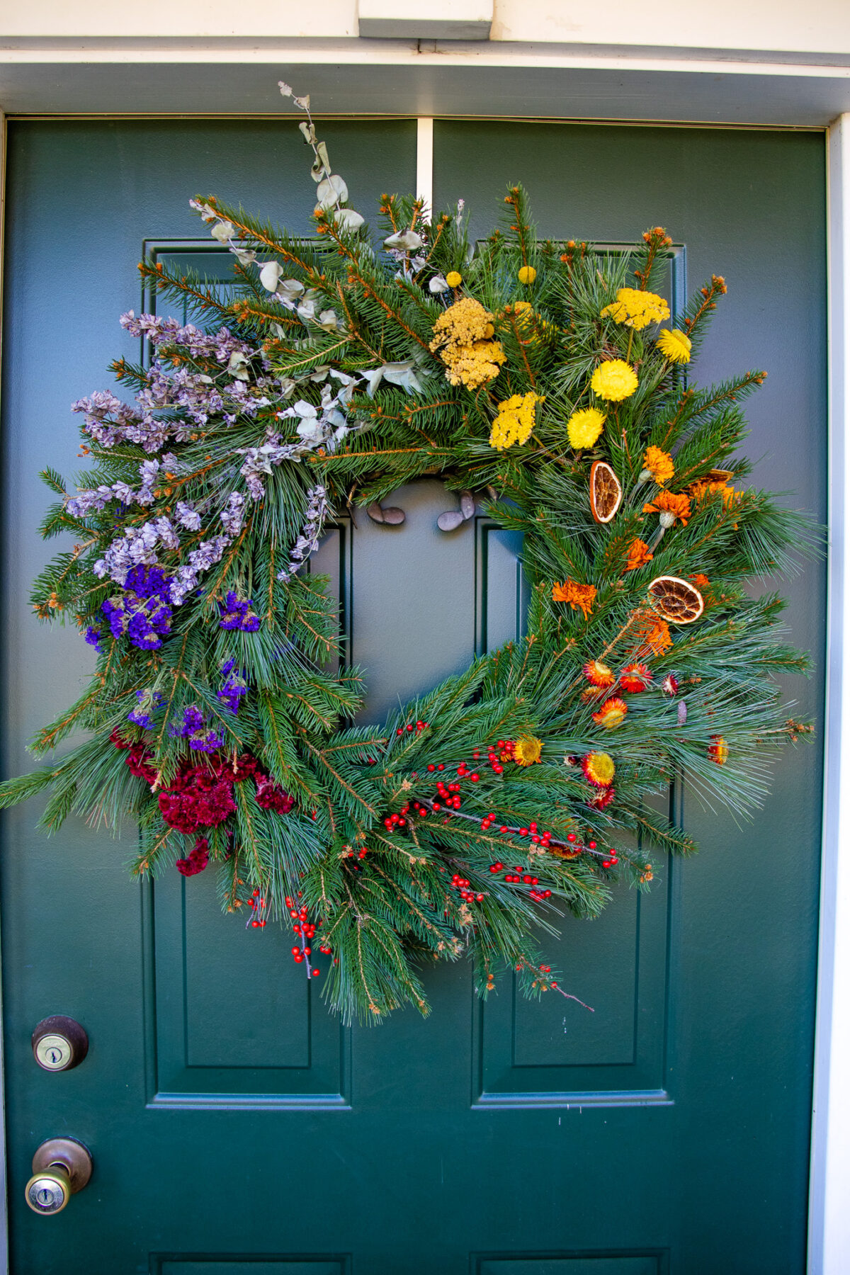 Rainbow Wreath hangs on a front door.