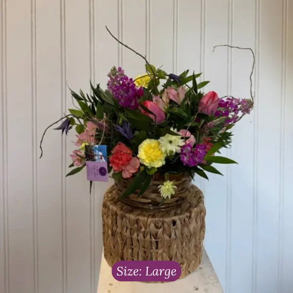 Large colorful funeral sympathy basket arrangement