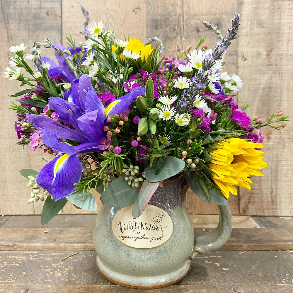 Flower Gift of stoneware mug with fresh floral arrangement in it.