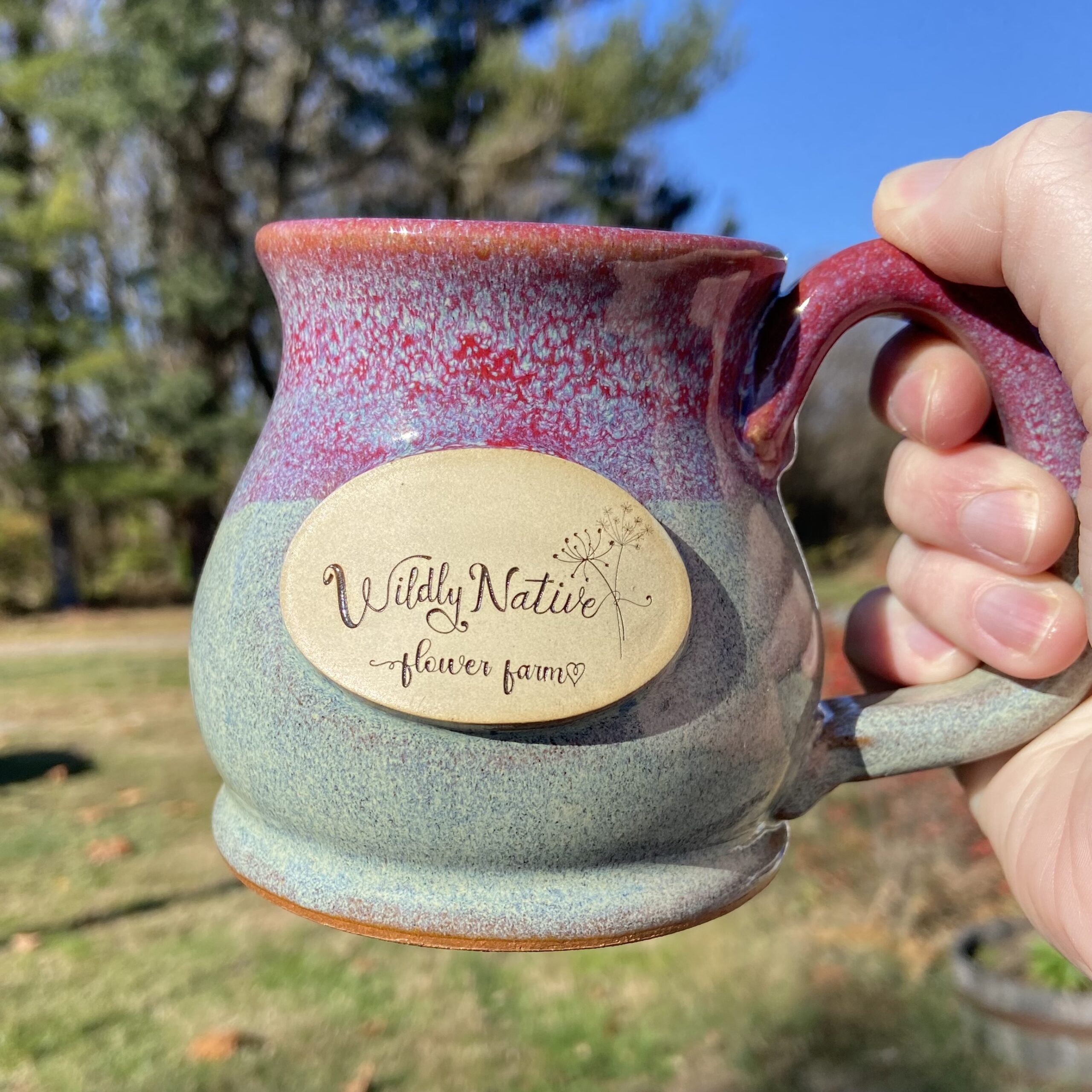 Stoneware Mug against sky and trees