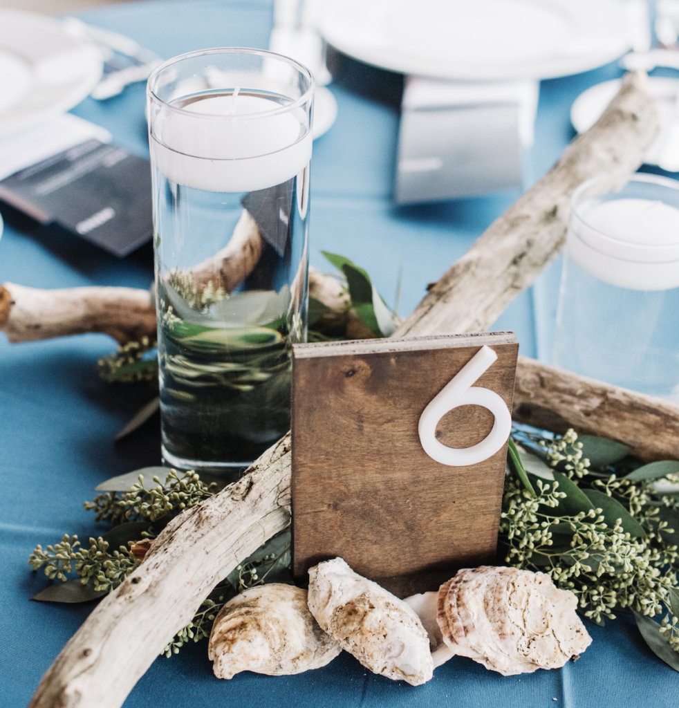 Round table at wedding with driftwood and floating candles as accent 