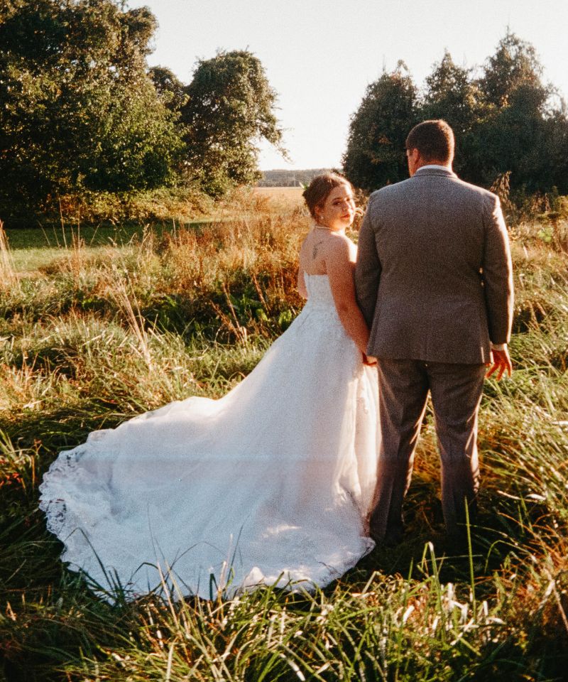 bride and groom standing in the sun