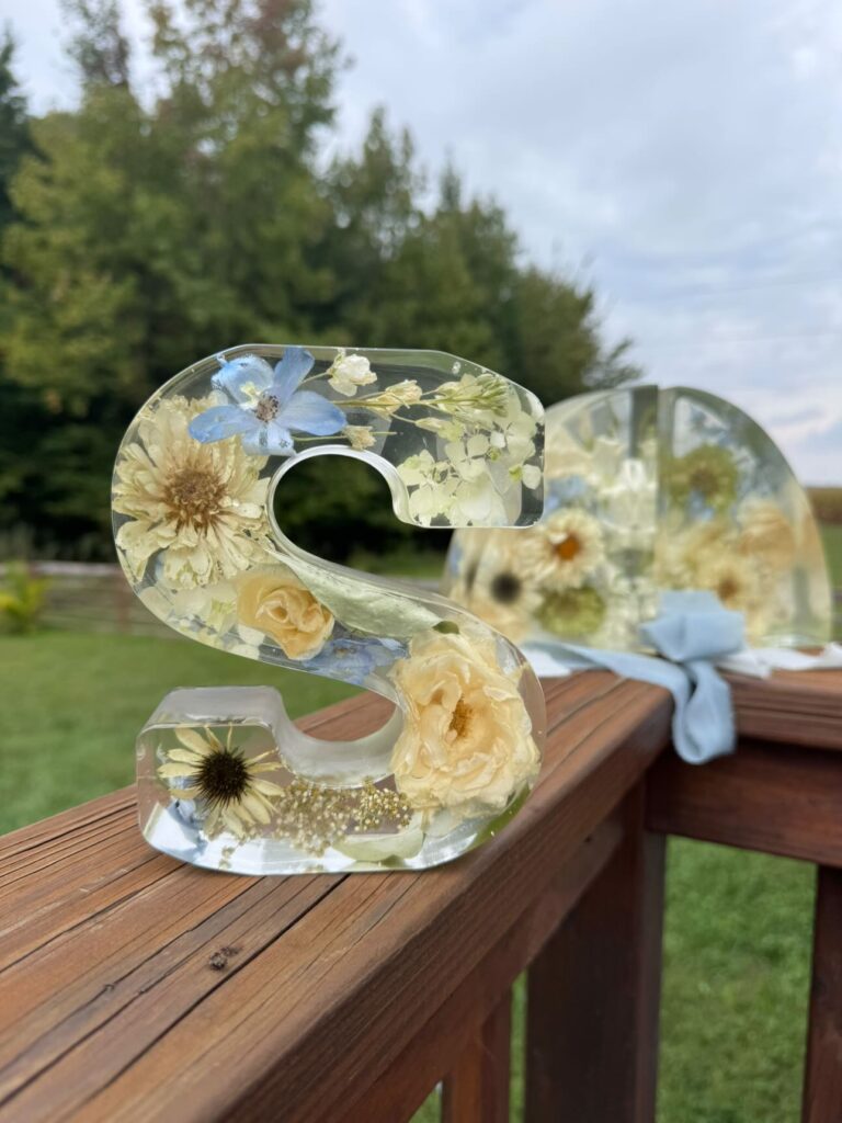 Preserved flower monogram resin art with blue and white wedding flowers.