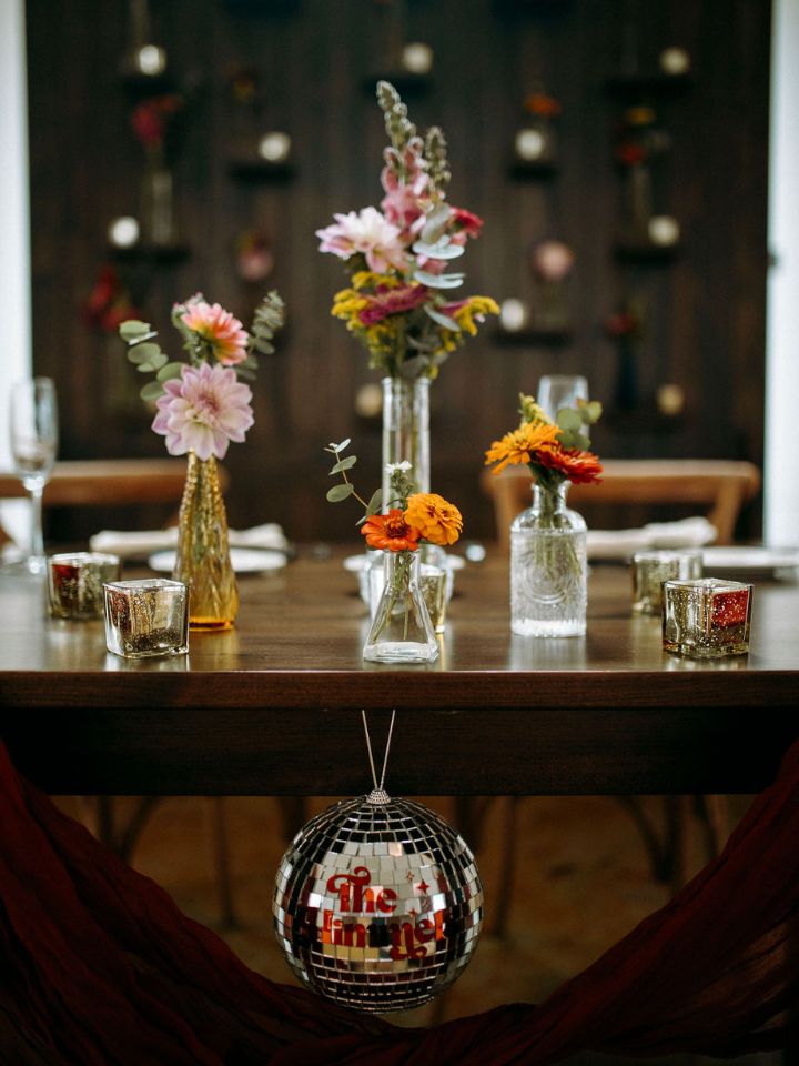 scattered vase on sweetheart table with bright florals