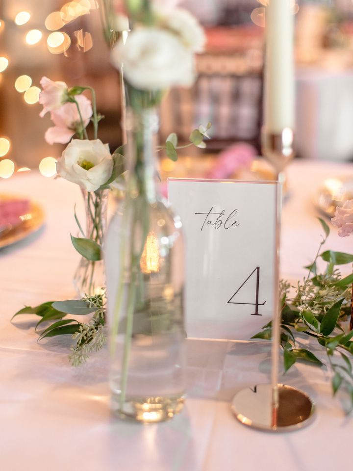 round tables with gold accents and bud vases