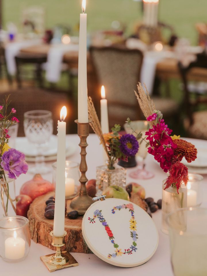 round table with wooden slab and bud vases