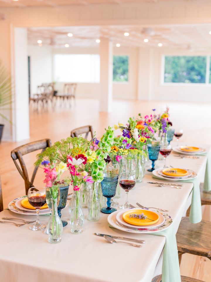 reception table at wylder hotel with rectangle table and bud vases with wildflowers
