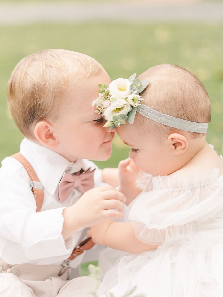 ring barer with flower girl on cart with floral headband