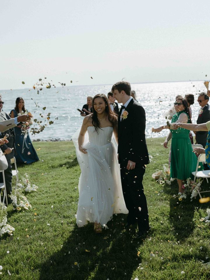 petal toss with bride and groom walking down the aisle