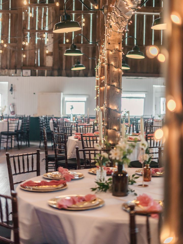 round tables with bud vases and candles