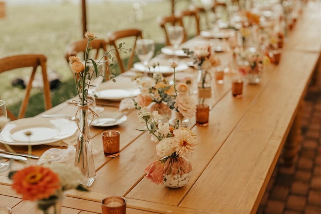 head table with bud vases and fancy vases with votives at brittland manor