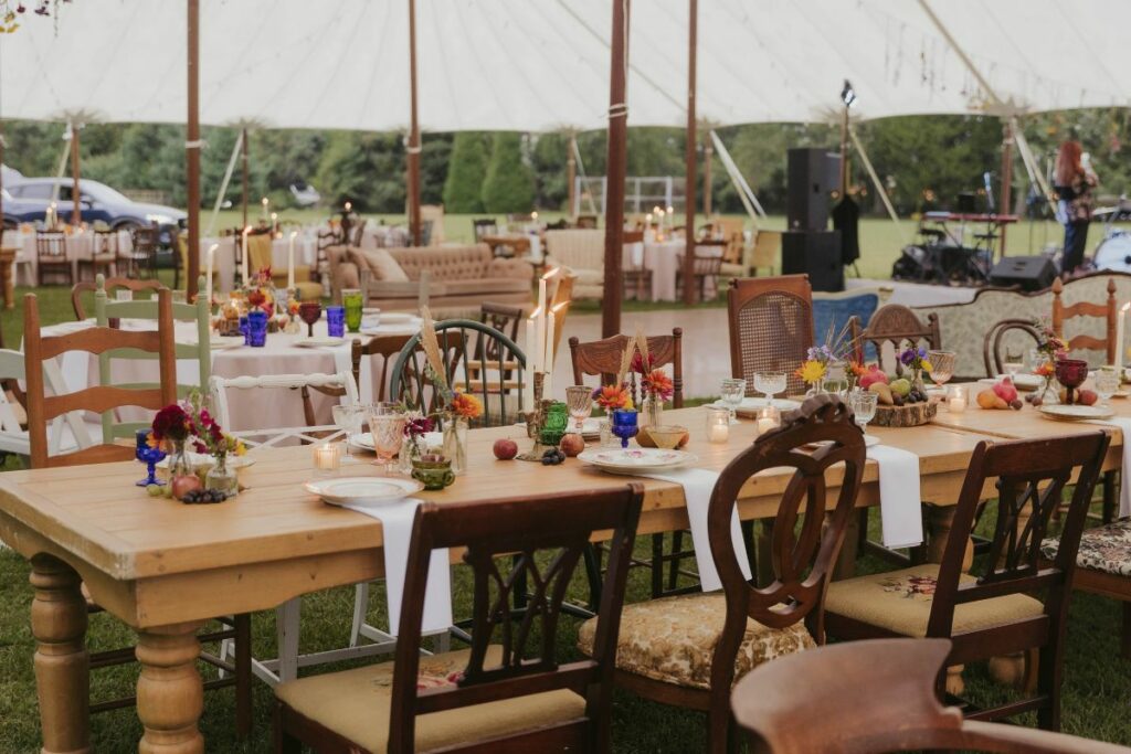 tent and tables with vases, candles, and votives