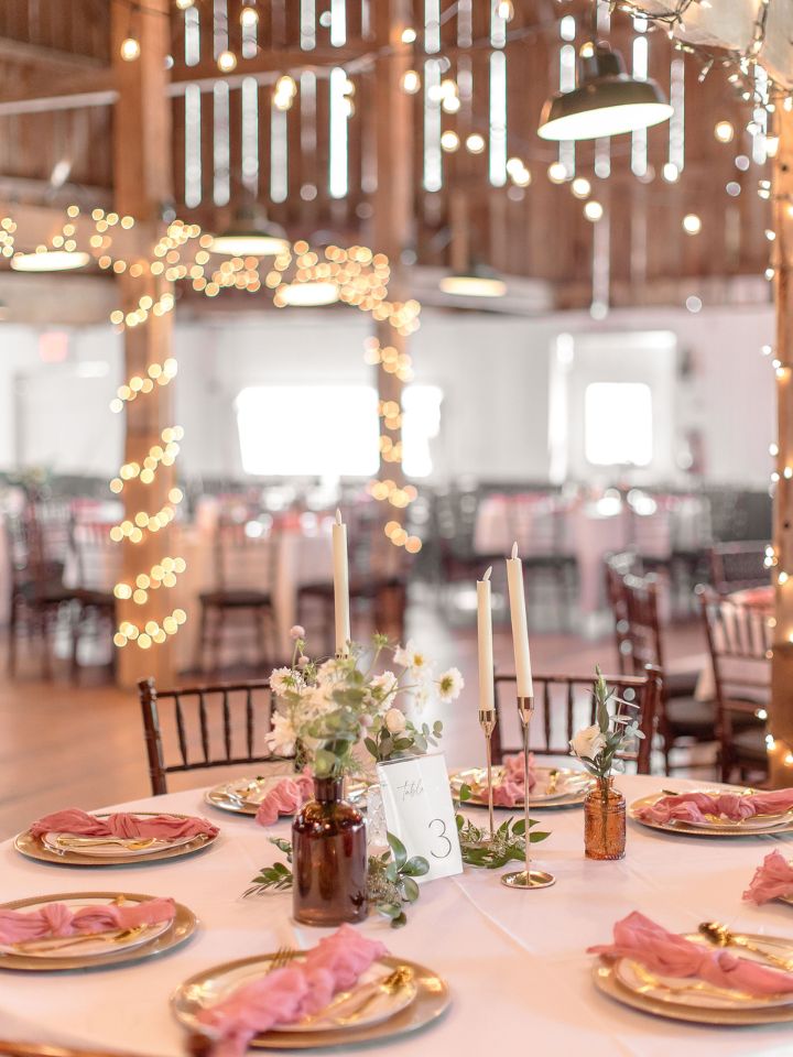 round tables with gold accents and bud vases