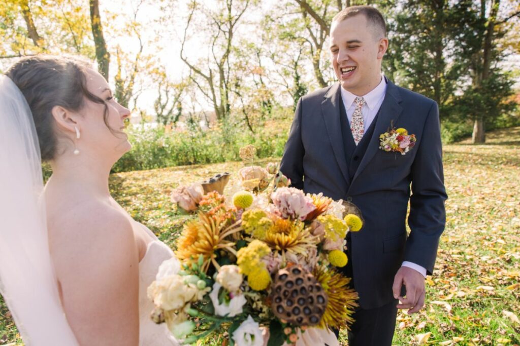 bride and groom first look with flowers