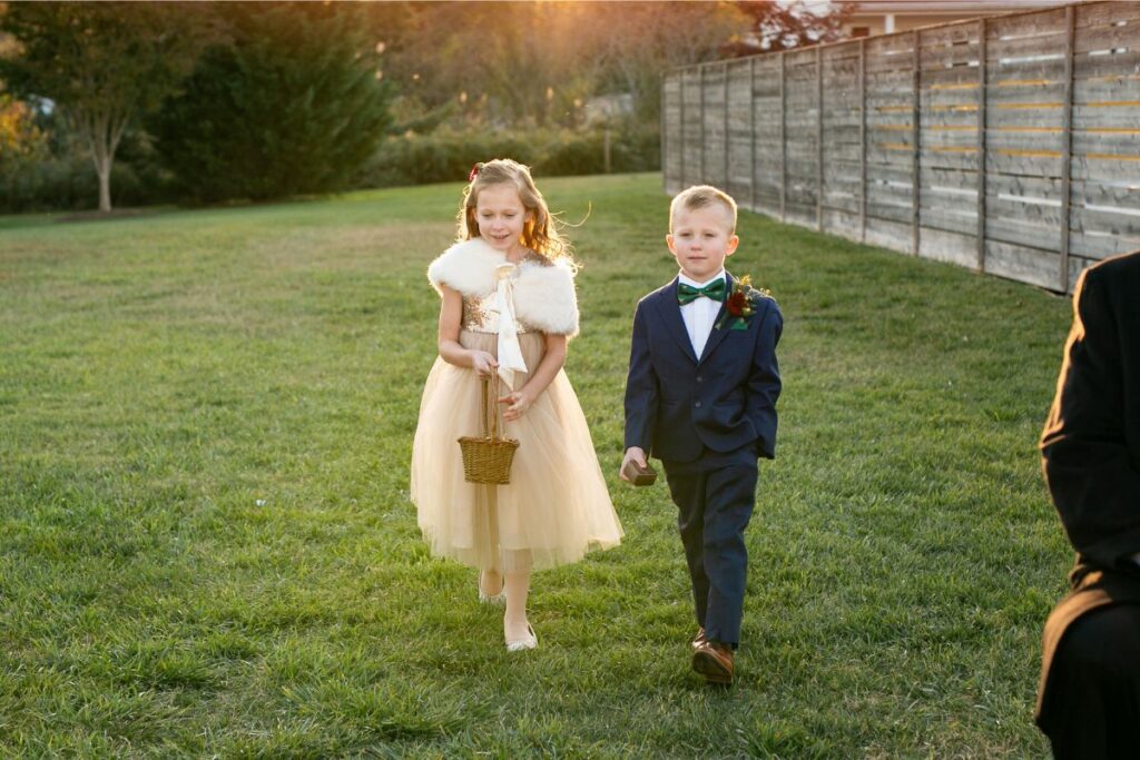 Flower girl and ring bearer walk down the aisle.