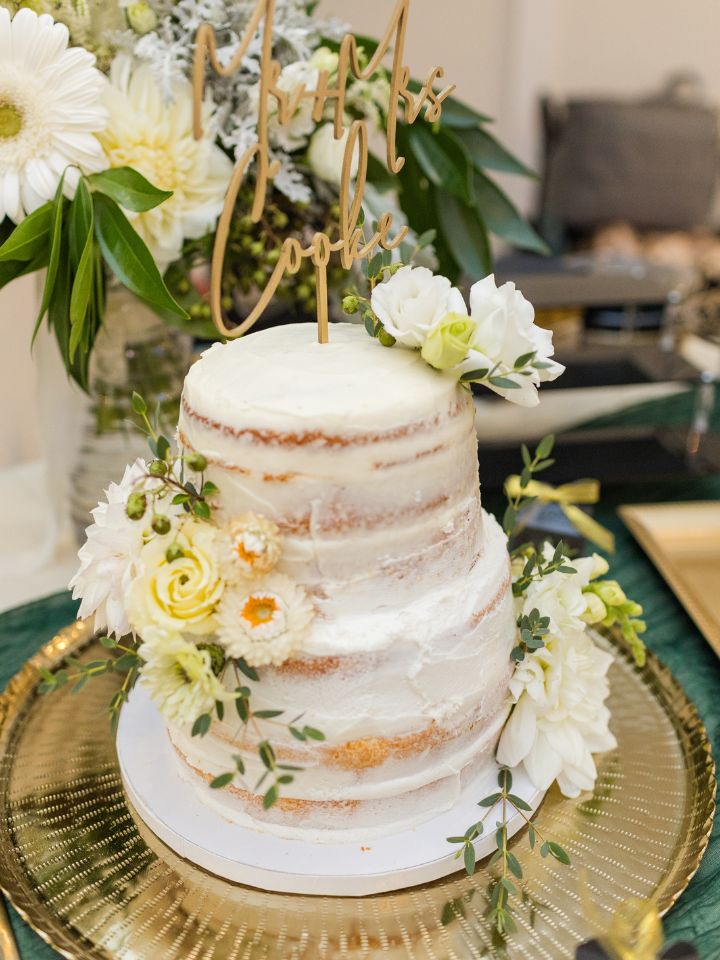 Three tiered cake with white icing and flowers.