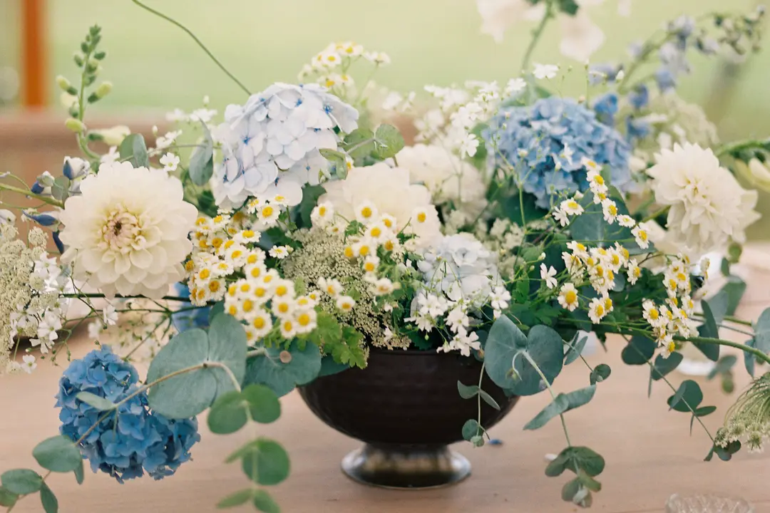A summer blue and white tabletop compote arrangement