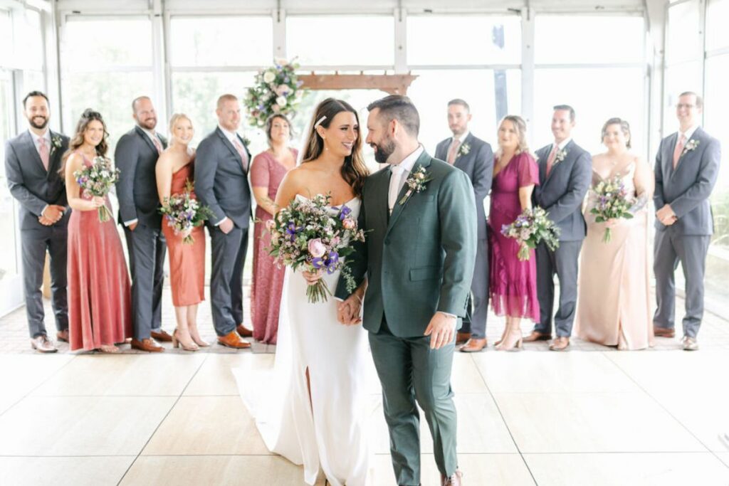Spring wedding entire wedding party lined up behind bride and groom.