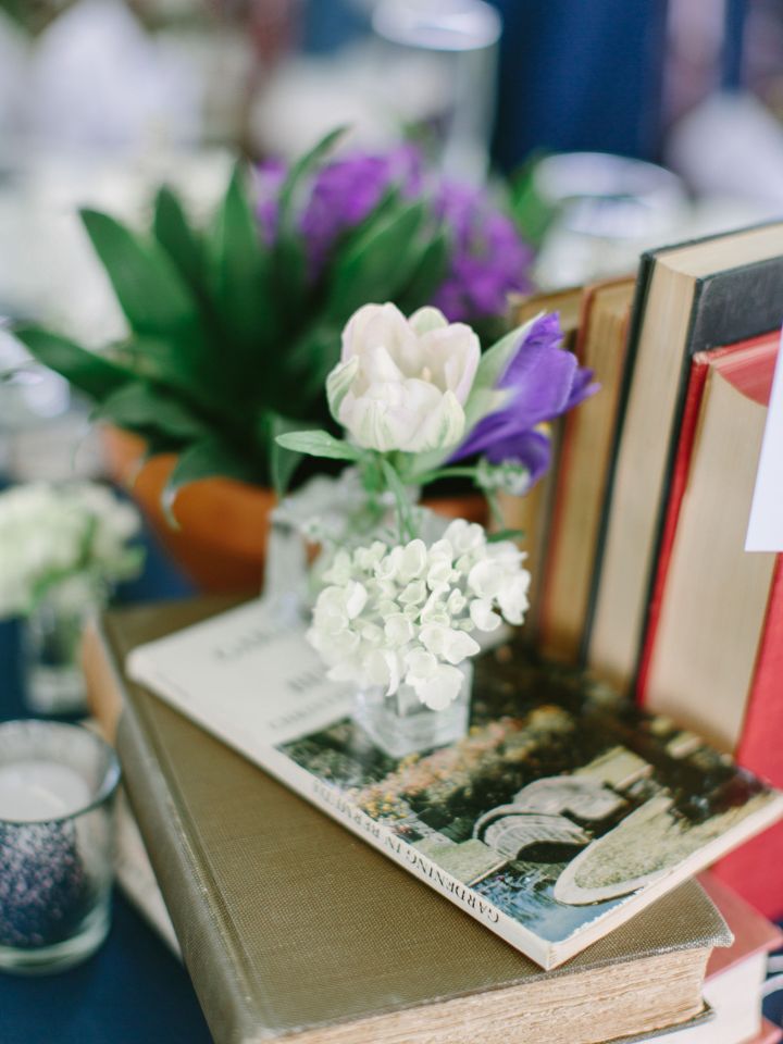 Bud vase sits on a stack of vintage books.