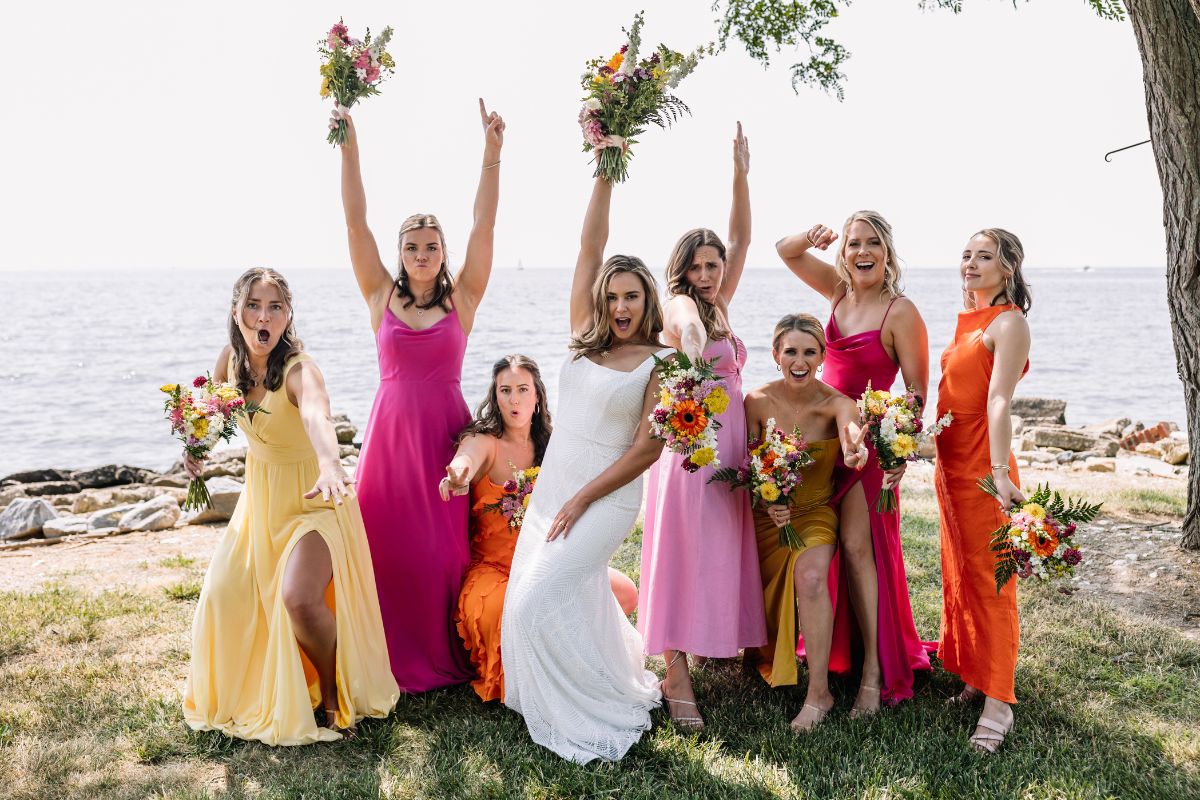 Leah Cover Bride and bridesmaids pose for a photo in bright summer colors.