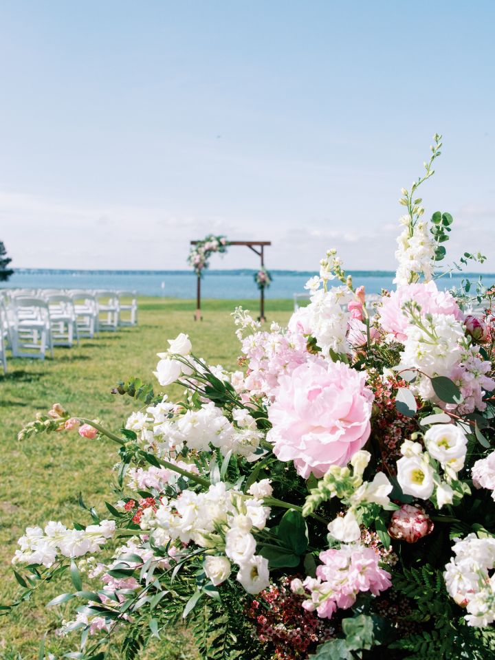Closeup of peony wedding flowers at the entrance to a wedding ceremony.