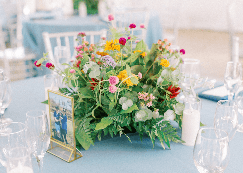 Floral Centerpiece at a Wedding by Sara Reynolds Events with Wildly Native Flower Farm on a blue linen tablecloth