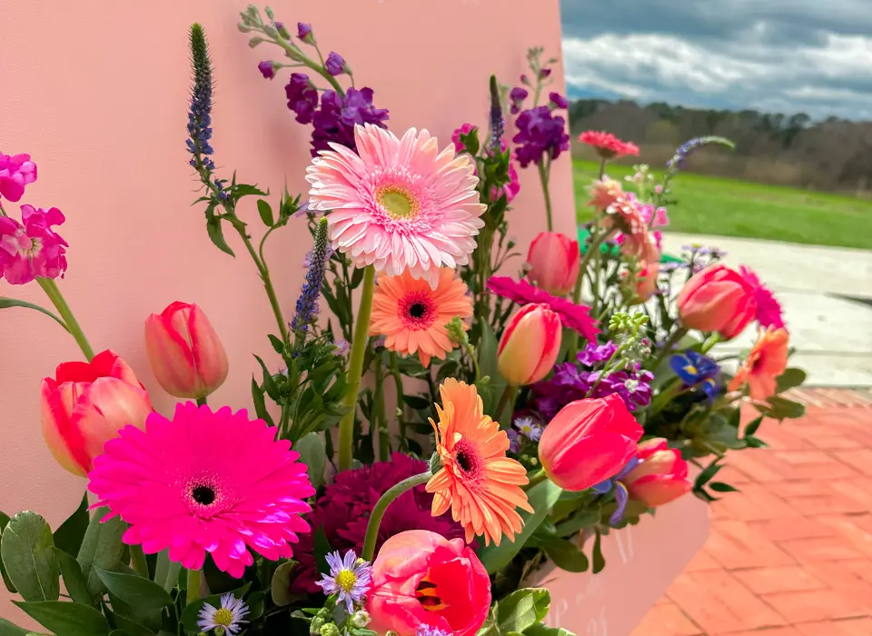 Up close view of a flower box sign for ceremony at a Spring wedding