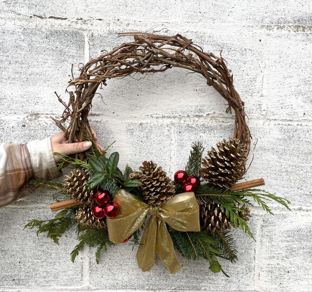 Medium Grapevine Wreath with gold bow and Christmas decor.