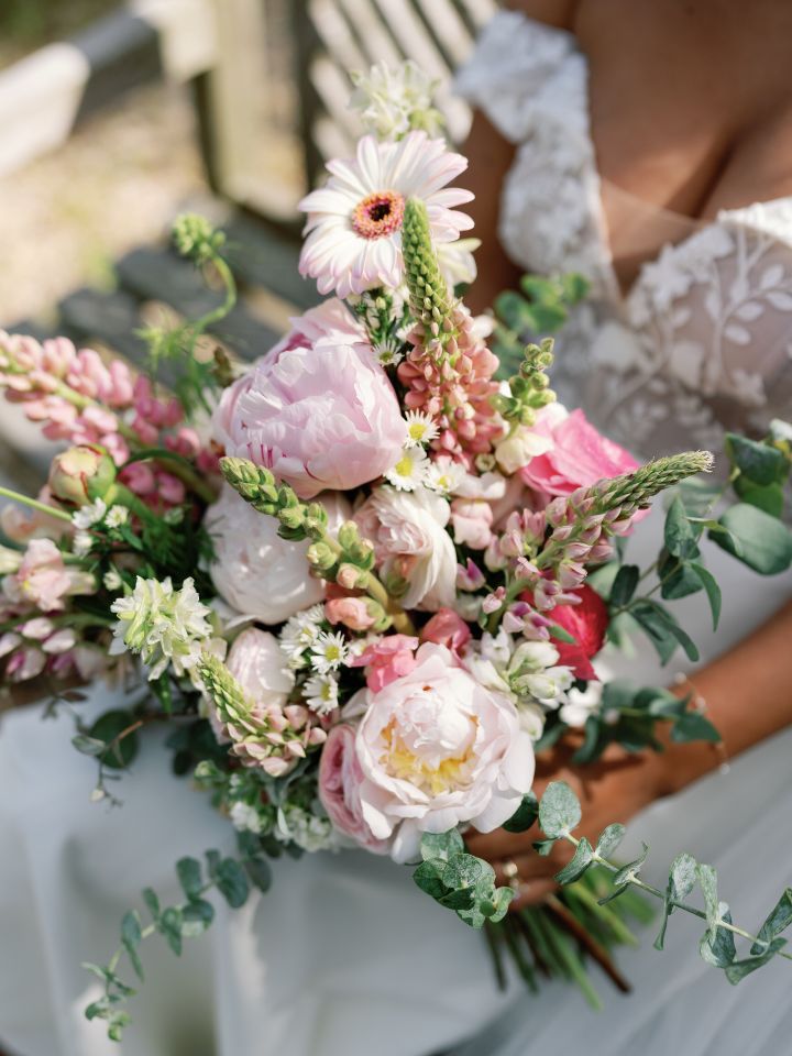 Meg Pink Bouquet Closeup of a bride holding her bouquet in shades of pale pink.