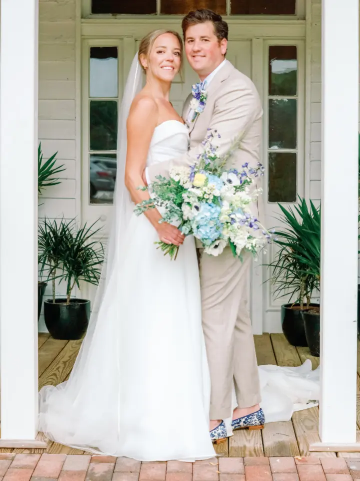 springbluewhite_wylderhotel2 Bride and Groom smiling at the camera at Wylder Hotel, bride is holding a blue and white bouquet