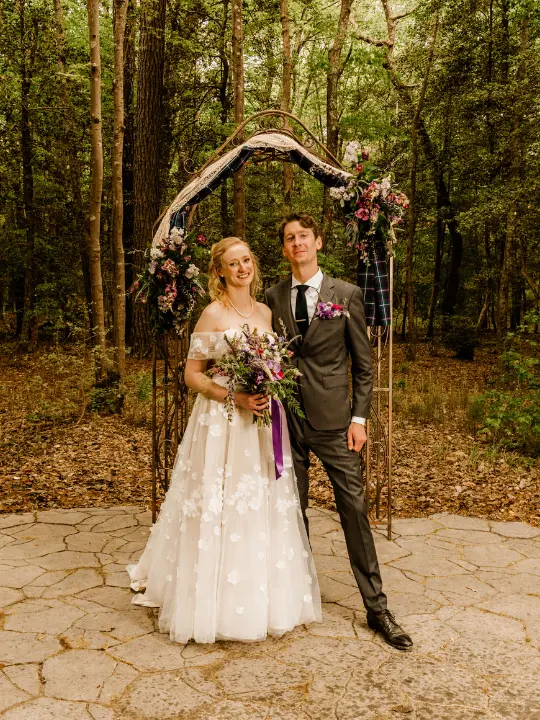 bridegroomcastlewedding Bride and groom under arbor