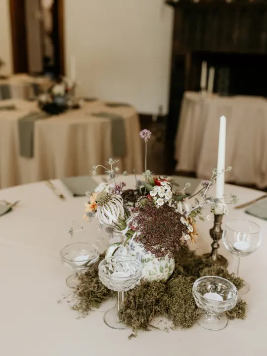 centerpiecearrangement Bride and groom under arbor