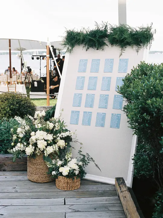 chesapeakebaymaritimemuseum_floralescortdisplay White floral baskets in front of an escort display at Chesapeake Bay Maritime Museum for a wedding