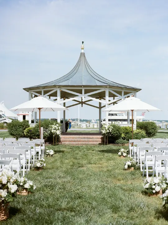 chesapeakebaymaritimemuseum_whitefloralsforceremony White florals for a ceremony setup at Chesapeake Bay Maritime Museum