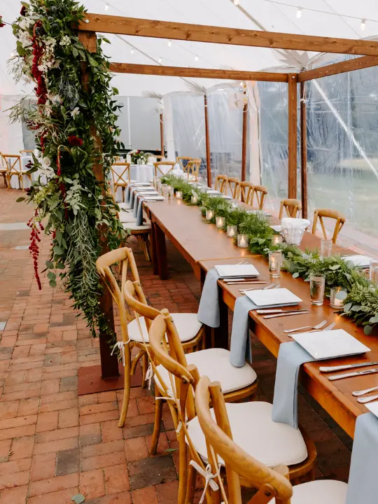 greenerywitharbor Tables with greenery and an arbor