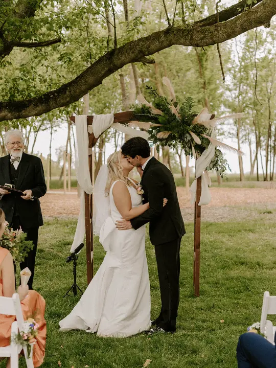 pastelspringkentislandresortwedding4 Bride and groom kissing at ceremony at Kent Island Resort