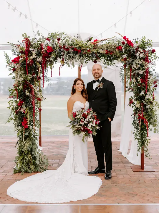redgreenerychuppah Red and White Florals with Greenery on a Chuppah at Brittland Estates