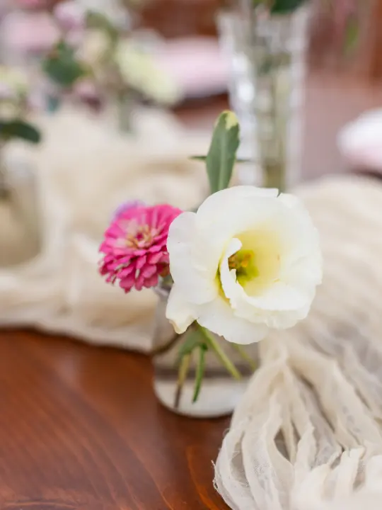scatteredvasewithcheeseclothrunner Scattered bud vases across a white cheesecloth runner