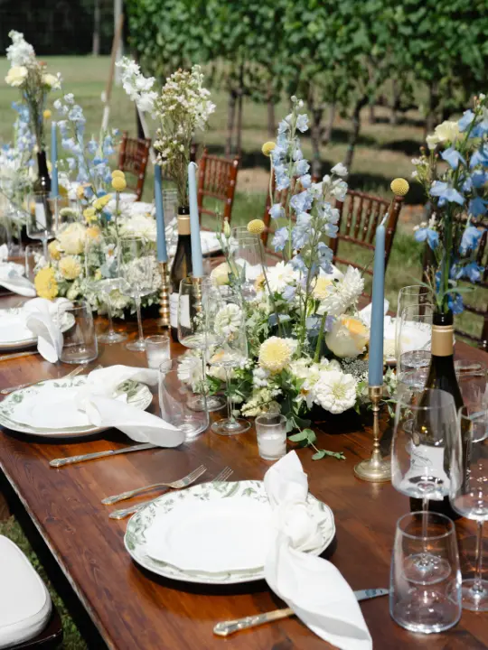 yellowwhitebluefloralarrangement Yellow, white, and blue floral arrangements for a farm table