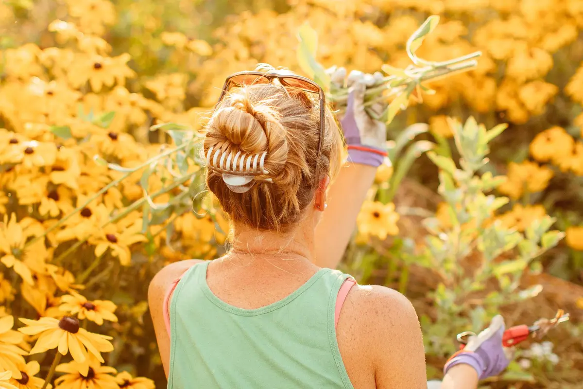 Liza cutting blooms in the flower field at Wildly Native Flower Farm