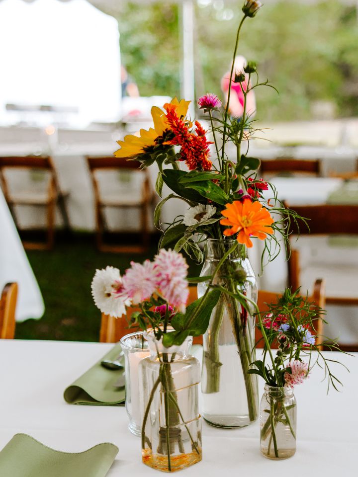 Fall DIY Wedding centerpieces of flower bud vases and candles.