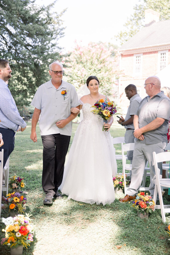 A Father walks his daughter down the aisle at her summer Eastern shore wedding.