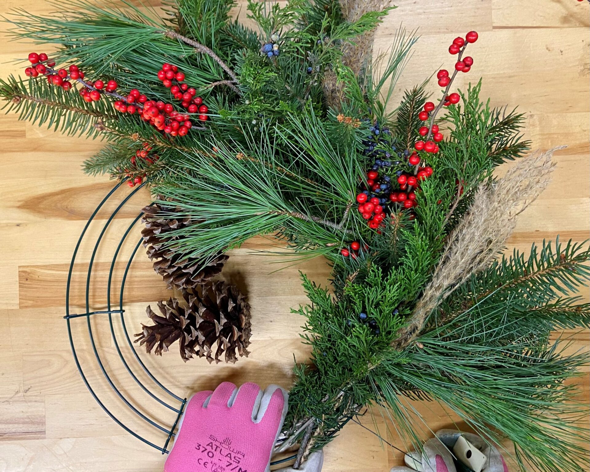 Make A Christmas Wreath Photo shows halfway through the process of making a DIY Christmas wreath.