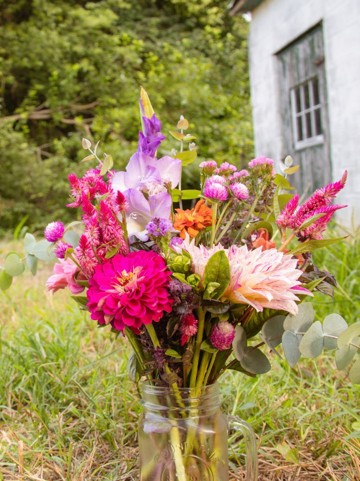 Grow cut flowers to create your own vases like this one full of pink and purple blooms.