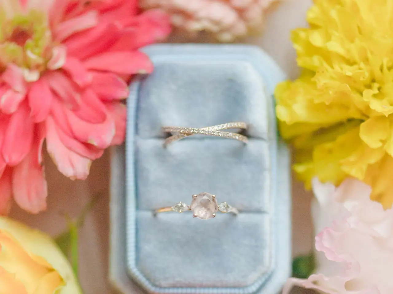A set of rings up close surrounded by flowers designed by Wildly Native Flower Farm