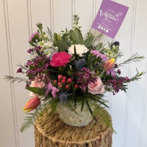 Pastel yellow basket with spring floral arrangement