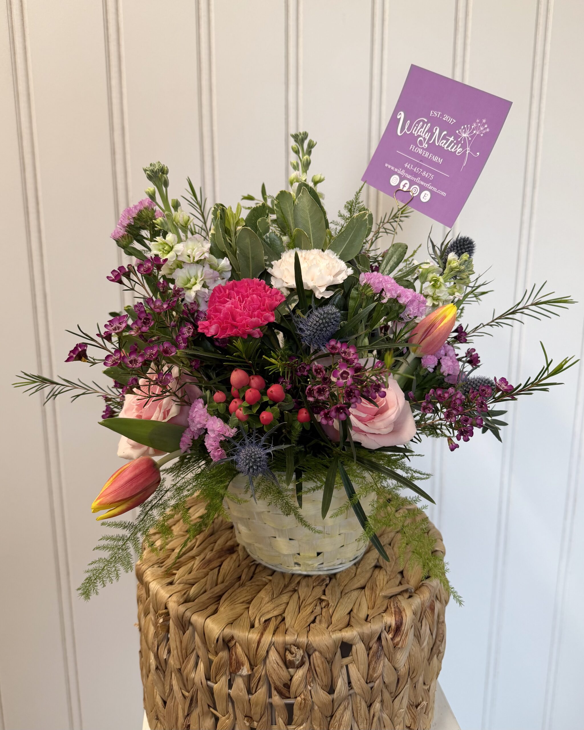 Pastel yellow basket with spring floral arrangement