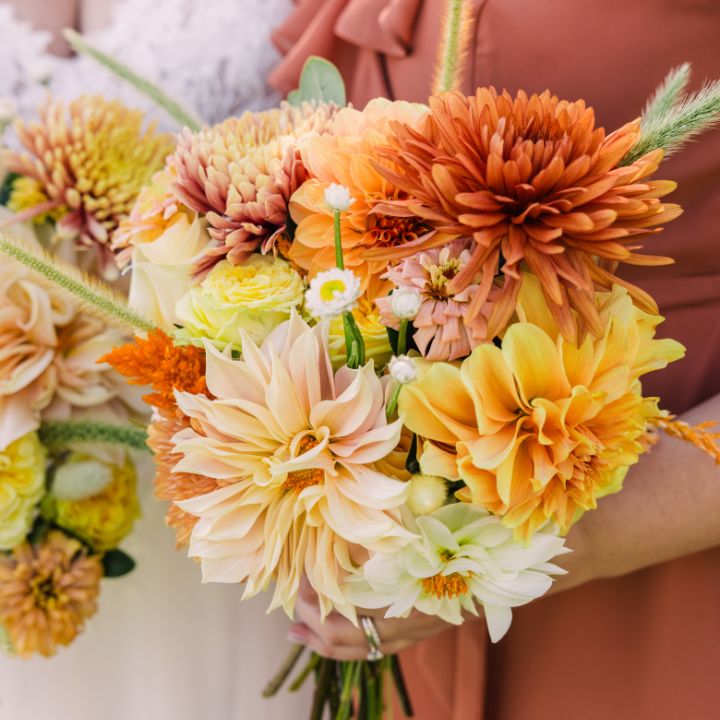 autumn flowers Dahlias in shades of orange in bridal and bridesmaid bouquets.